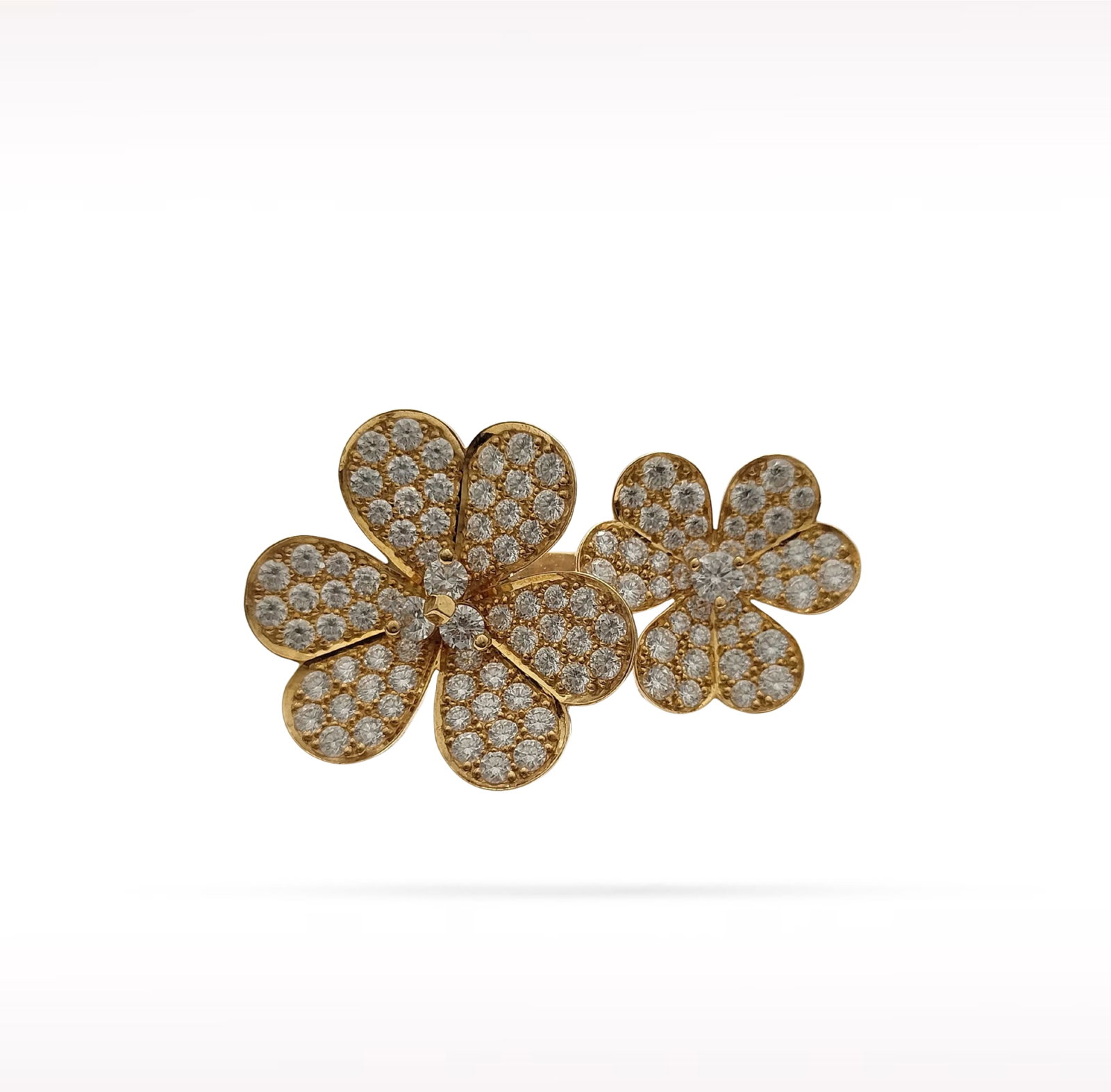Van Cleef & Arpels Frivole Between the Finger Double Flower Pave Diamond 18K Yellow Gold Ring: Description: Van Cleef & Arpels Frivole Between the Finger Double Flower ring crafted in 18K yellow gold and accented with natural pave set diamonds. From the iconic Frivole collection, this elega