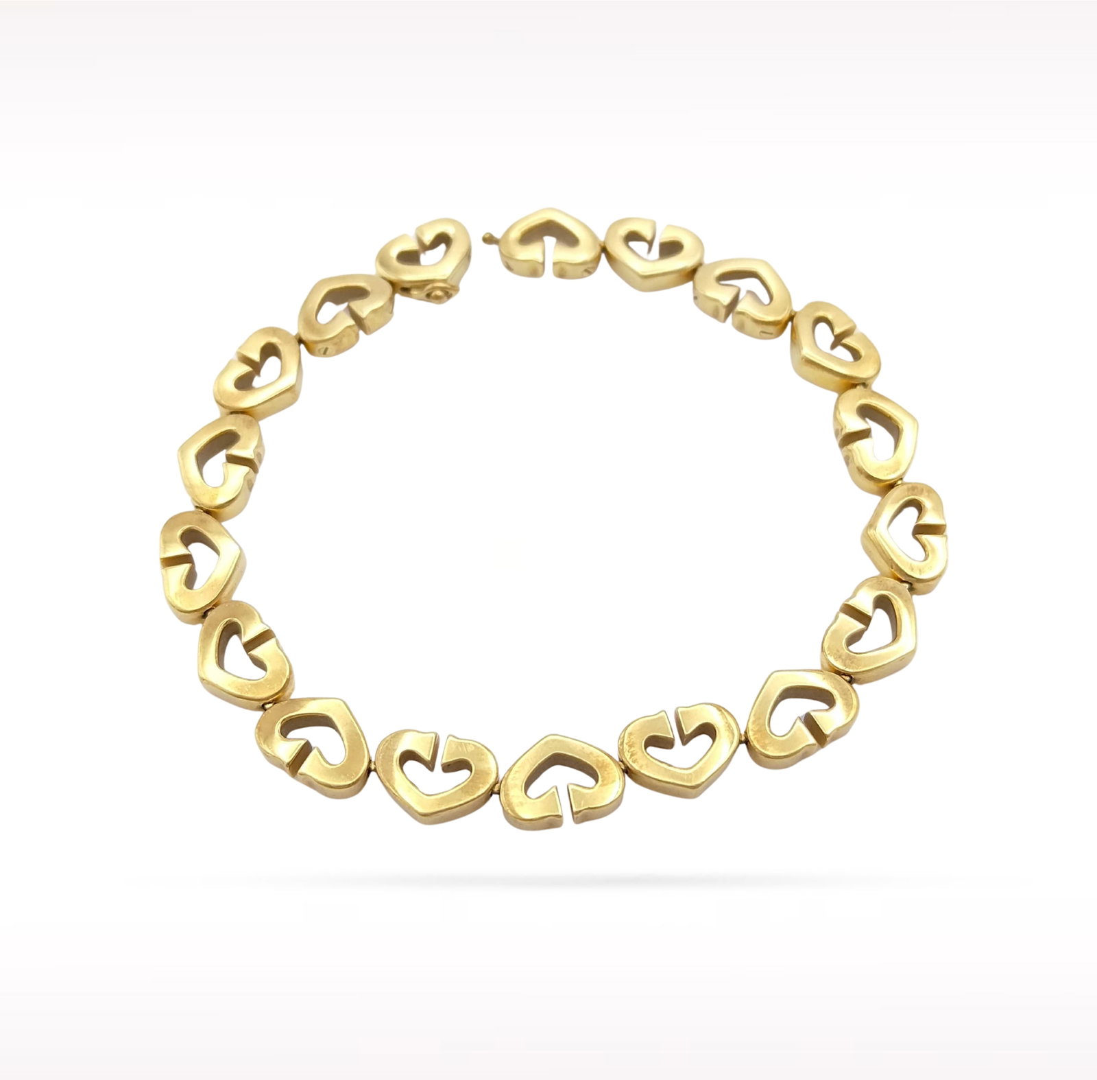 Cartier Open Heart C Link Multi Motif 18K Yellow Gold Bracelet: Description: Cartier Open Heart C Link Multi Motif bracelet crafted in 18K yellow gold. This elegant bracelet features a series of Cartier's signature Open Heart and iconic C Link motifs, creating a r