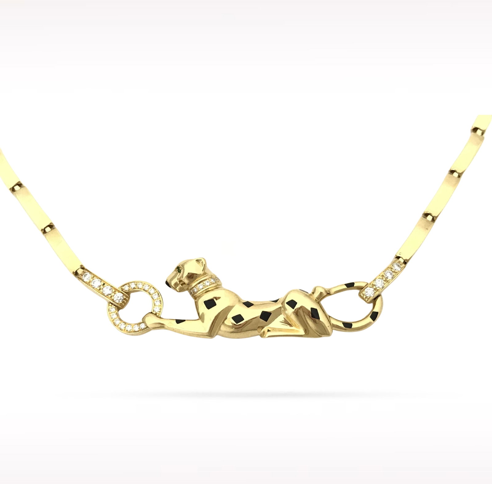 Cartier Panthere Diamond Tsavorite Black Lacquer 18K Yellow Gold Necklace: Description: Cartier Panthere necklace crafted in 18K yellow gold and accented with natural diamonds, vivid tsavorites, and black lacquer. From the iconic Panthere collection, this exceptional necklac
