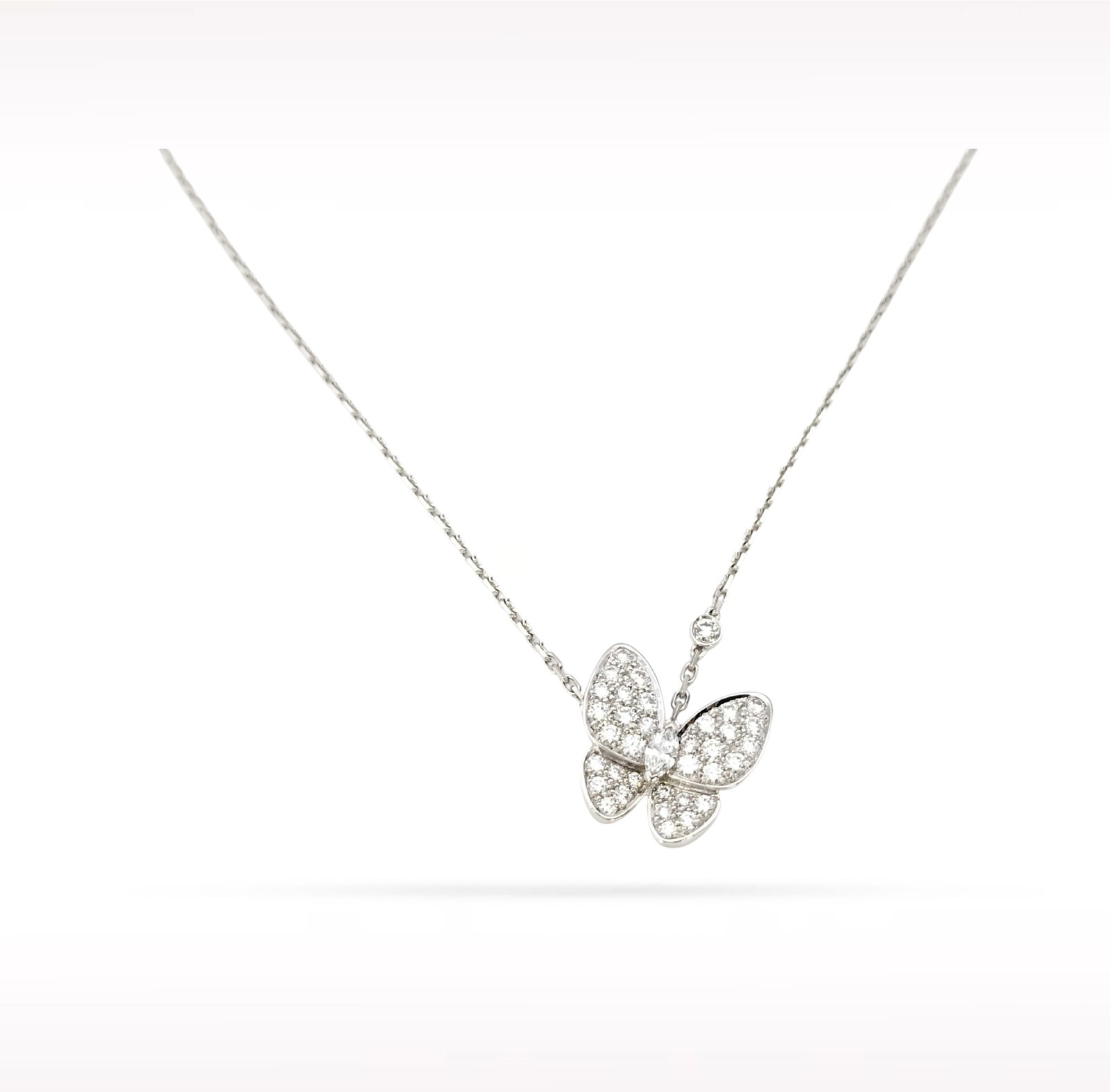 Van Cleef & Arpels Two Butterfly Pave Diamond 18K White Gold Pendant Necklace: Description: Van Cleef & Arpels Two Butterfly pendant necklace crafted in 18K white gold and accented with natural pave set diamonds. Inspired by the beauty and grace of nature, this elegant penda
