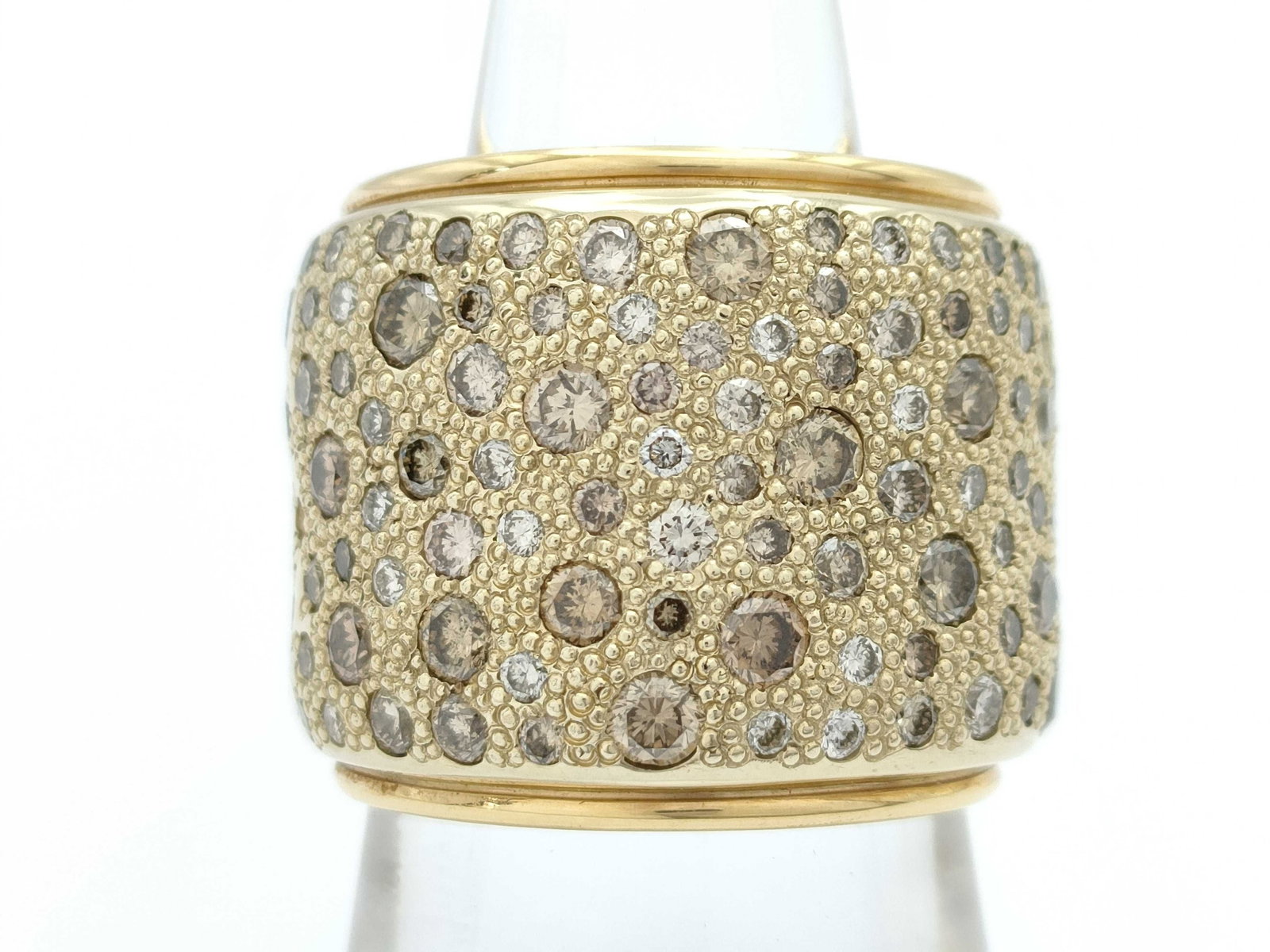 Pomellato Sabbia Fancy Color Diamond 18K Yellow Gold Band Ring: Description: Striking Pomellato Sabbia ring crafted in solid 18K yellow gold, featuring the iconic Sabbia design set with a mix of sparkling diamonds arranged in an organic pavé pattern. The wide