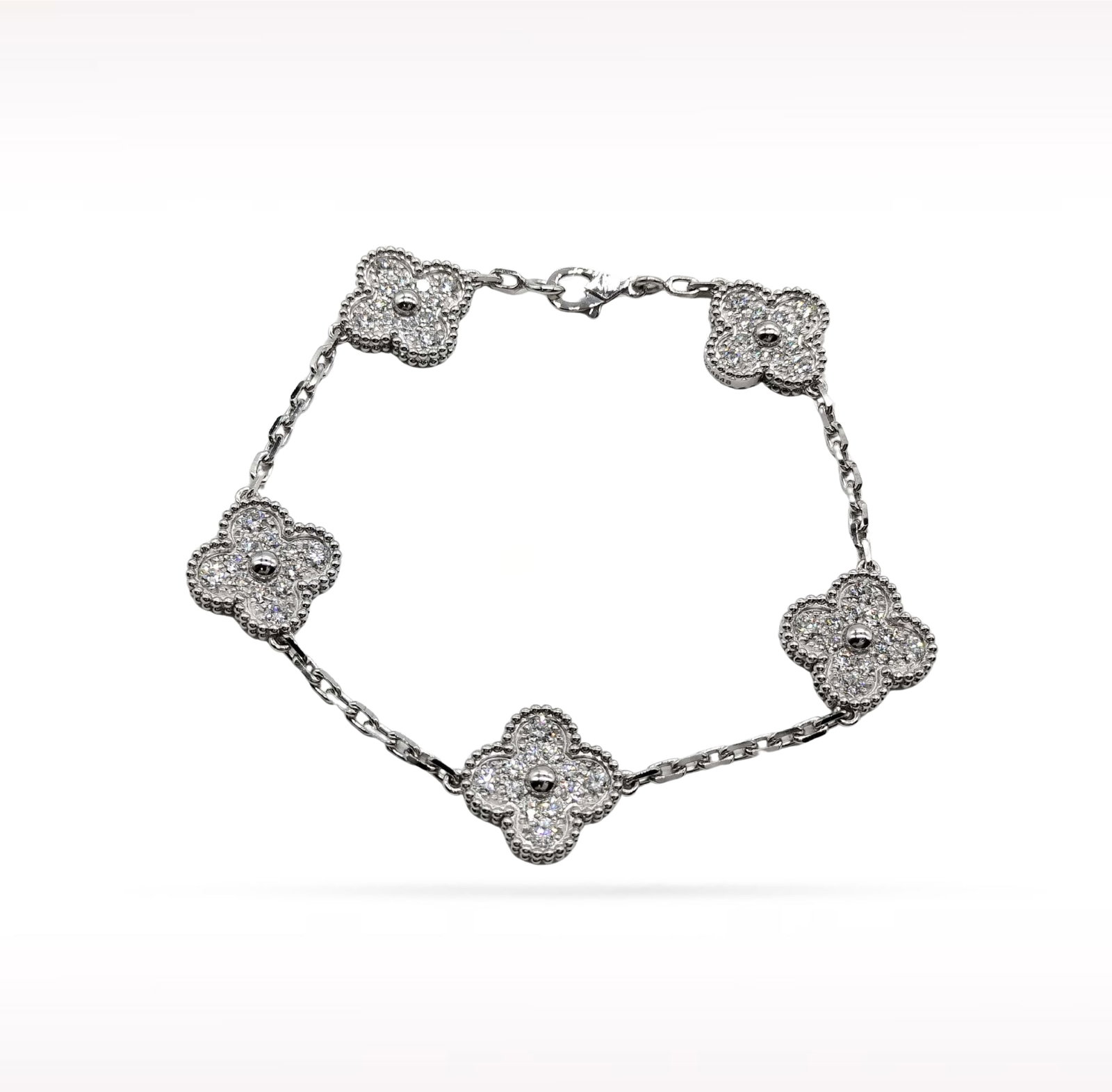 Van Cleef & Arpels Vintage Alhambra Pave Diamond 18K White Gold 5 Motif Bracelet: Description: Van Cleef & Arpels Alhambra 5 Motif bracelet crafted in 18K white gold and accented with natural pave set diamonds. From the iconic Alhambra collection, this elegant bracelet features