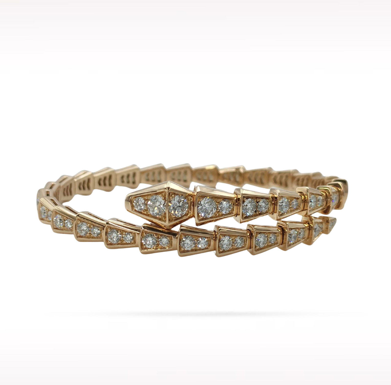 Bvlgari Serpenti Viper Diamond 18K Rose Gold Bangle Bracelet: Description: Bvlgari Serpenti Viper bangle bracelet crafted in 18K rose gold and accented with natural diamonds. From the iconic Serpenti Viper collection, this elegant bracelet features the collectio