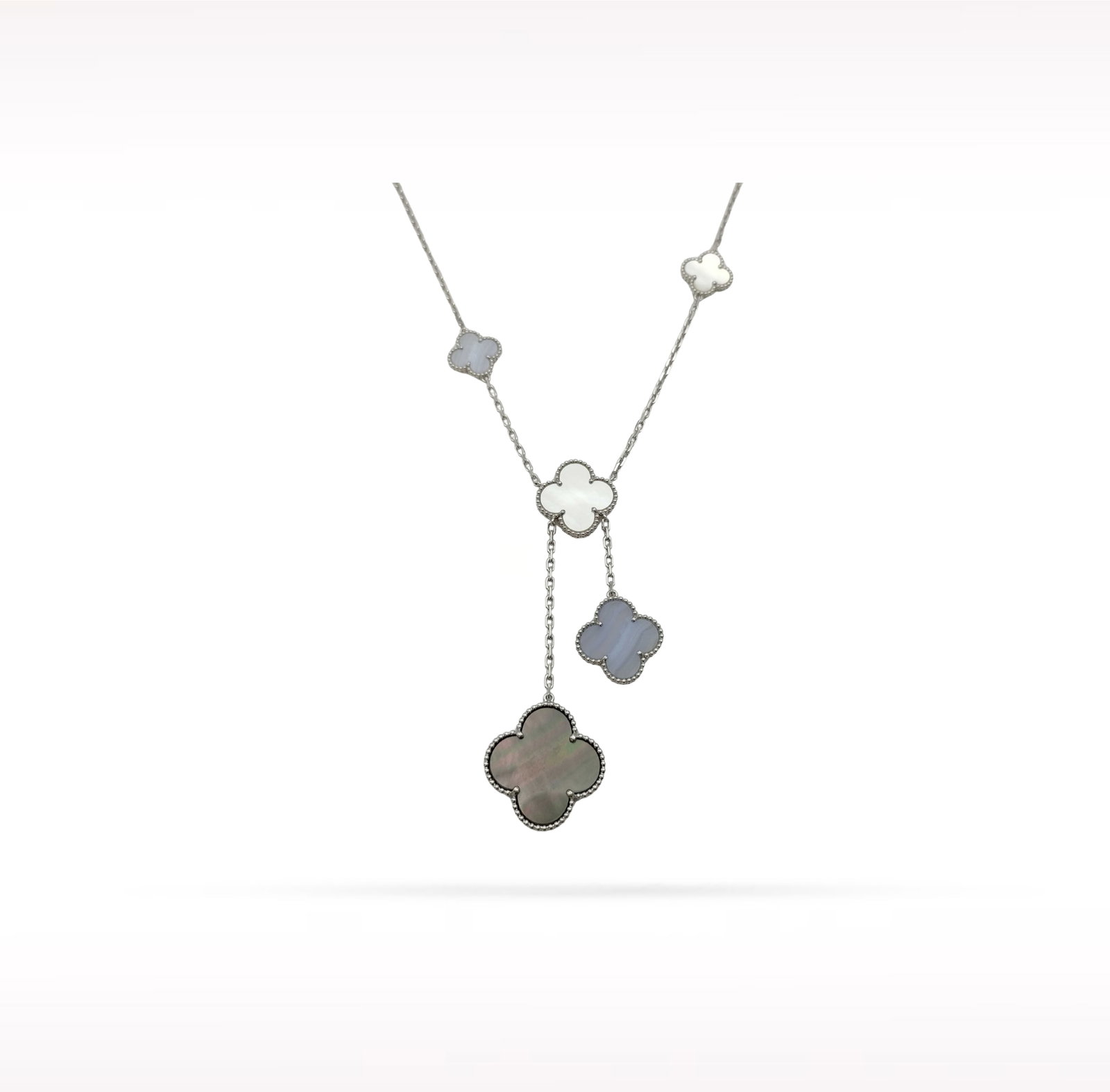 Van Cleef & Arpels Magic Alhambra White Mother of Pearl Chalcedony 18K White Gold 6 Motif Necklace: Description: Van Cleef & Arpels Magic Alhambra 6 Motif necklace crafted in 18K white gold and accented with natural white mother of pearl and chalcedony. From the iconic Magic Alhambra collection,