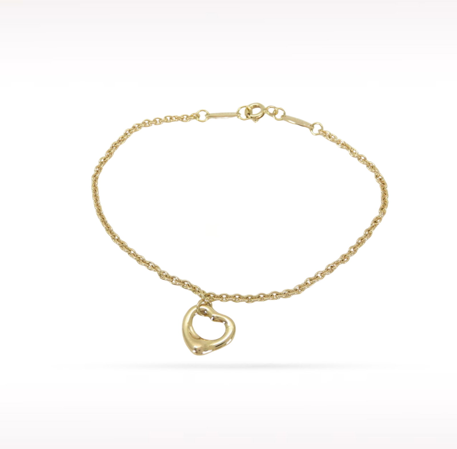 Tiffany & Co. Elsa Peretti Open Heart 18K Yellow Gold Charm Bracelet: Description: Tiffany & Co. Elsa Peretti Open Heart charm bracelet crafted in 18K yellow gold. Designed by Elsa Peretti, the iconic Open Heart motif symbolizes love, elegance, and timeless simplici
