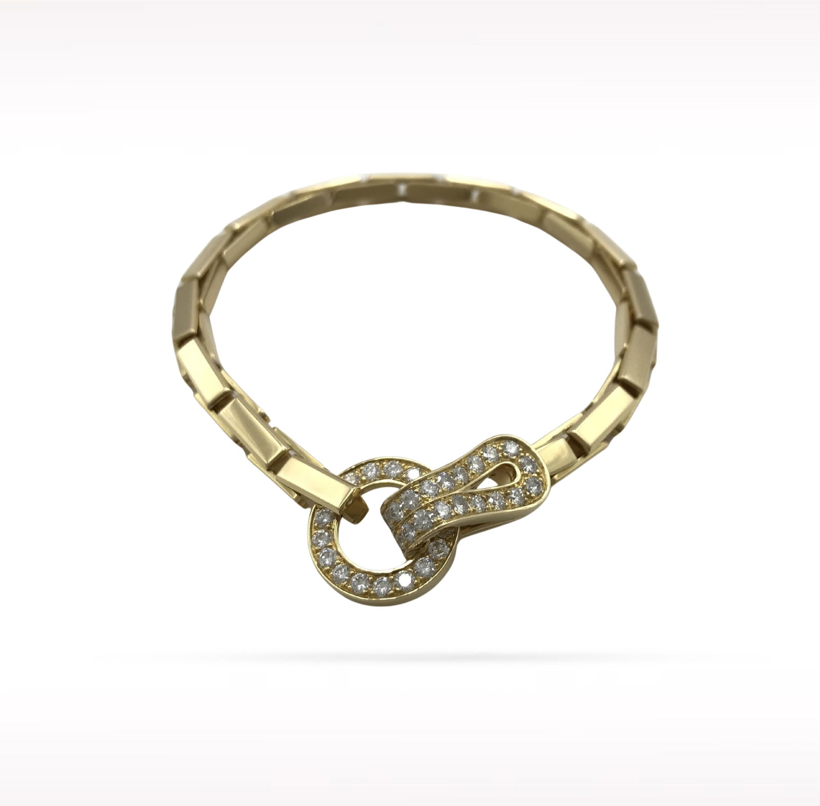 Cartier Agrafe Pave Diamond 18K Yellow Gold Bracelet: Description: Cartier Agrafe bracelet crafted in 18K yellow gold and accented with natural pave set diamonds. From the iconic Agrafe collection, this elegant bracelet is inspired by the refined silhoue