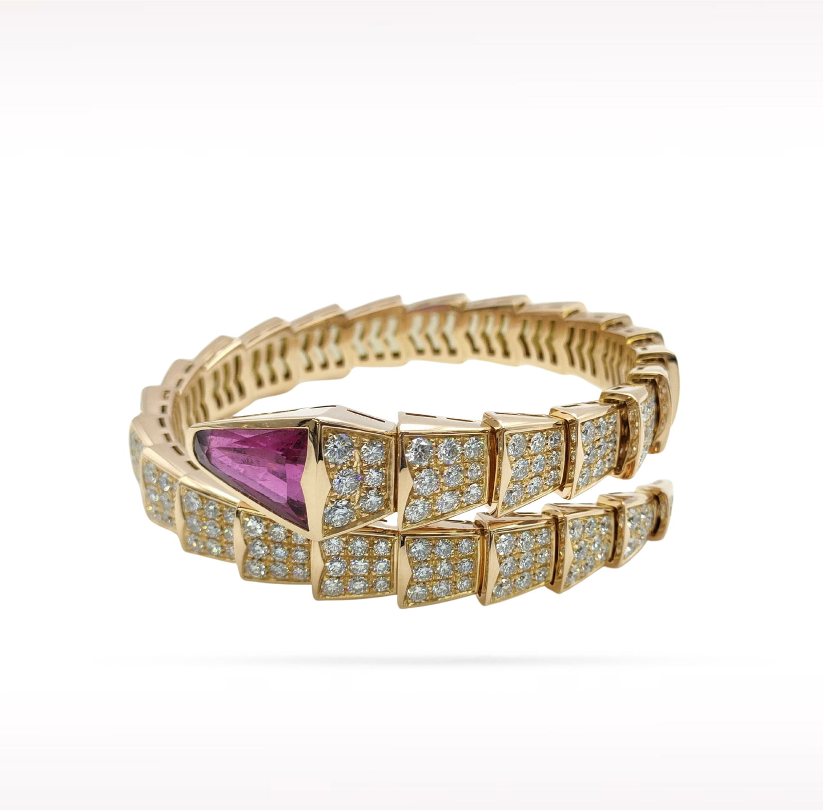 Bvlgari Serpenti Rubellite Pave Diamond 18K Rose Gold Size M Bangle Bracelet: Description: Bvlgari Serpenti bangle bracelet crafted in 18K rose gold and accented with natural pave set diamonds and a vibrant rubellite. Inspired by the iconic Serpenti collection, this elegant des