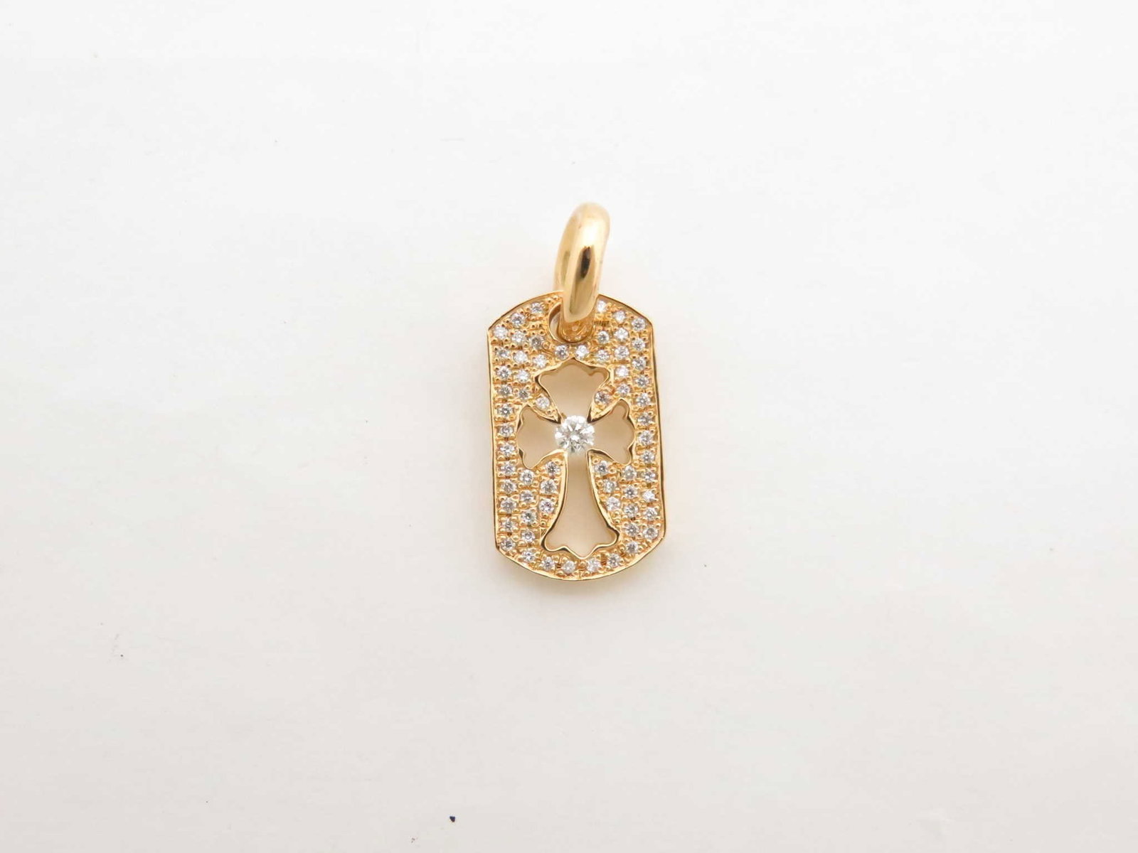 Chrome Hearts Cut Out Cross Pave Diamond Gold Pendant: Description: Distinctive Chrome Hearts Cut Out Cross pendant crafted in solid gold, featuring the iconic gothic cross silhouette framed by pave diamonds. The openwork design enhances dimension and con