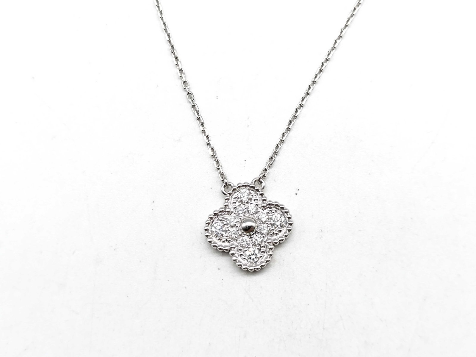 Van Cleef & Arpels Vintage Alhambra Pave Diamond 18K White Gold Pendant Necklace: Description: Van Cleef & Arpels Vintage Alhambra pendant necklace crafted in 18K white gold and accented with natural pave set diamonds. From the iconic Vintage Alhambra collection, this elegant p