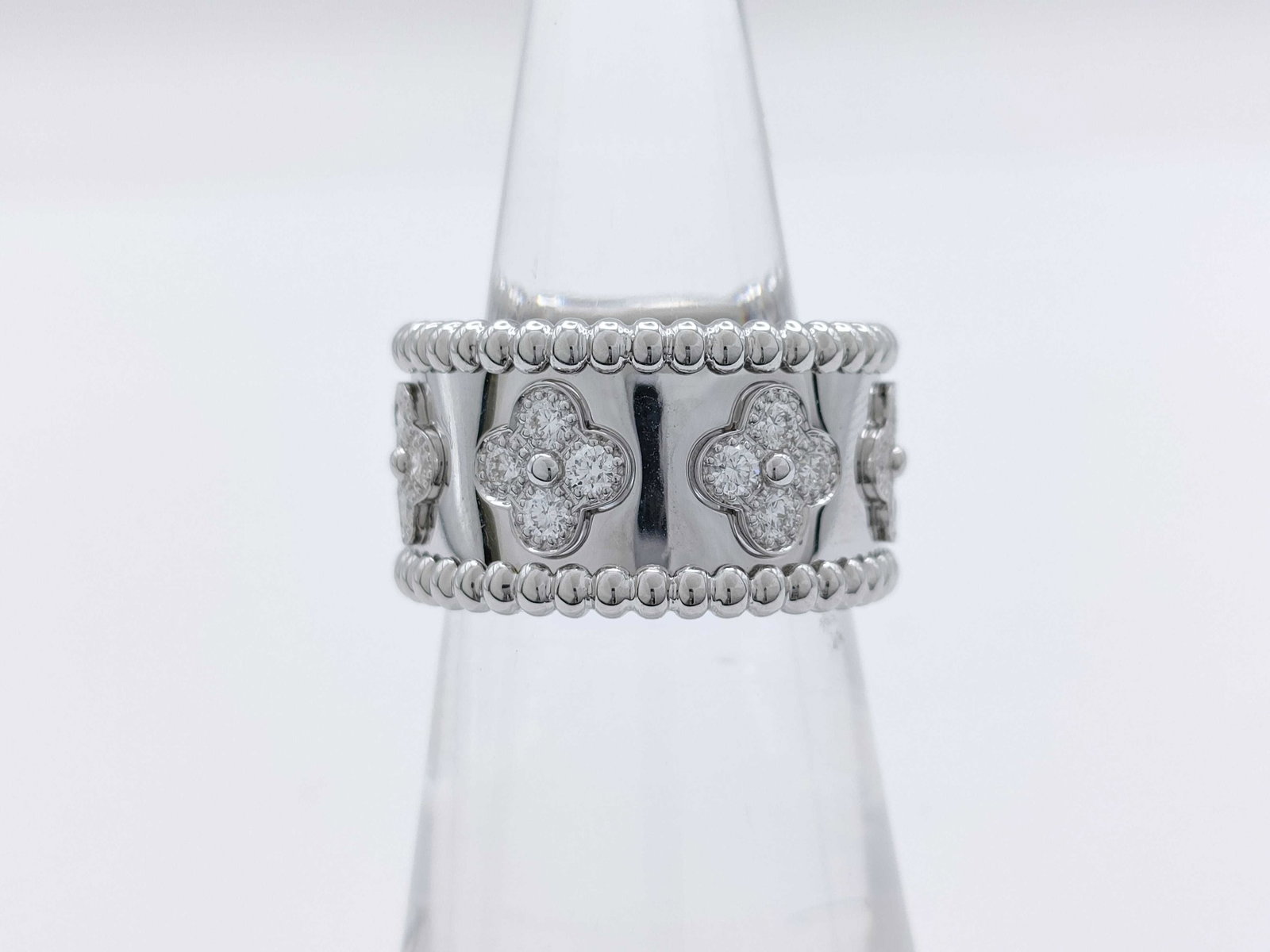 Van Cleef & Arpels Perlee Diamond Clover 18K White Gold Ring: Description: This elegant Van Cleef & Arpels Perlee Clover ring is crafted in solid white 18K gold and features the signature clover motif accented with brilliant diamonds. The refined design high