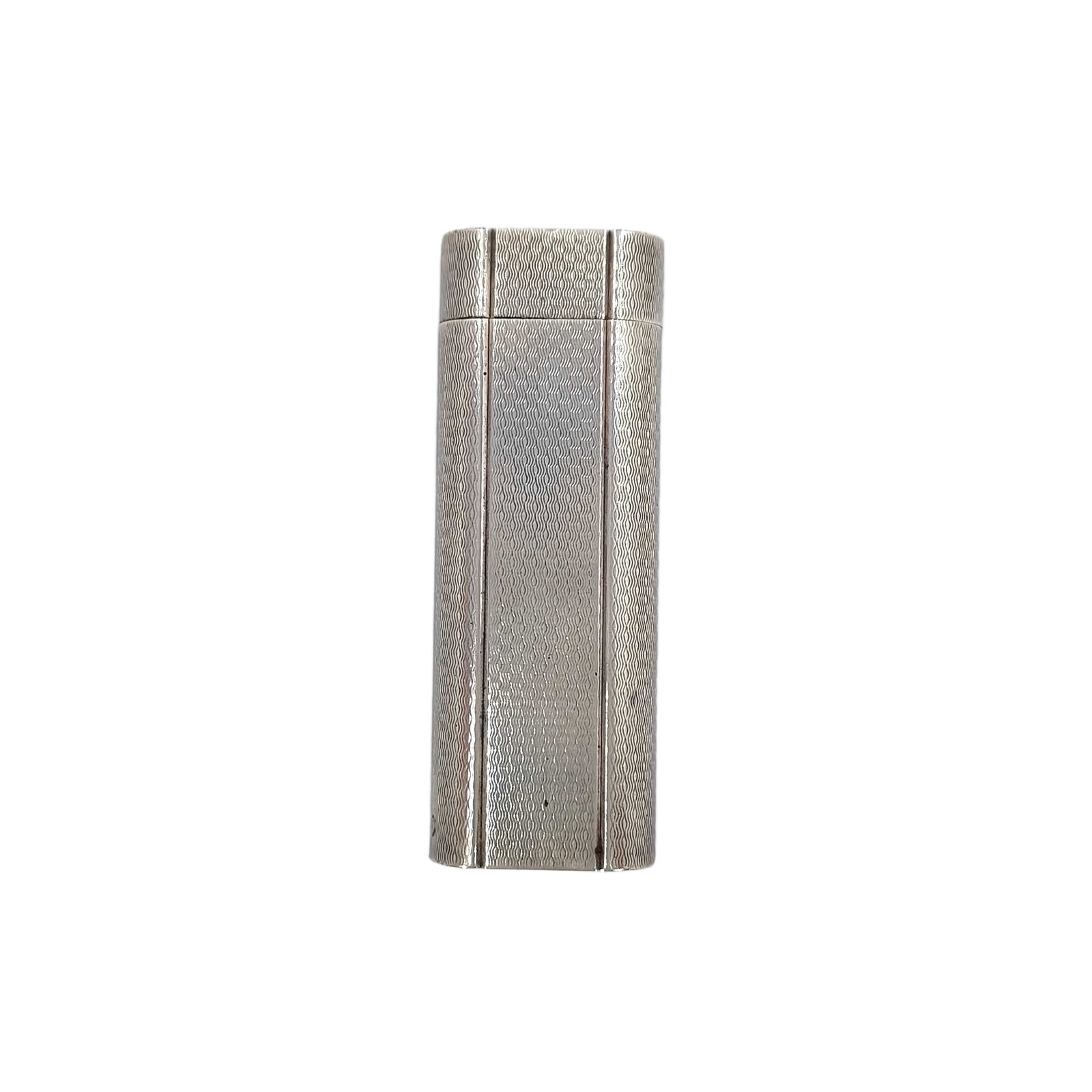 Vintage Cartier Swiss Made Textured Silver Tone Metal Lighter: Title/Medium: Vintage Cartier textured silver tone metal lighter Origin/Year: Swiss Made; vintage period Dimensions: Not provided Condition: Pre-owned vintage condition with visible surface wear, scra