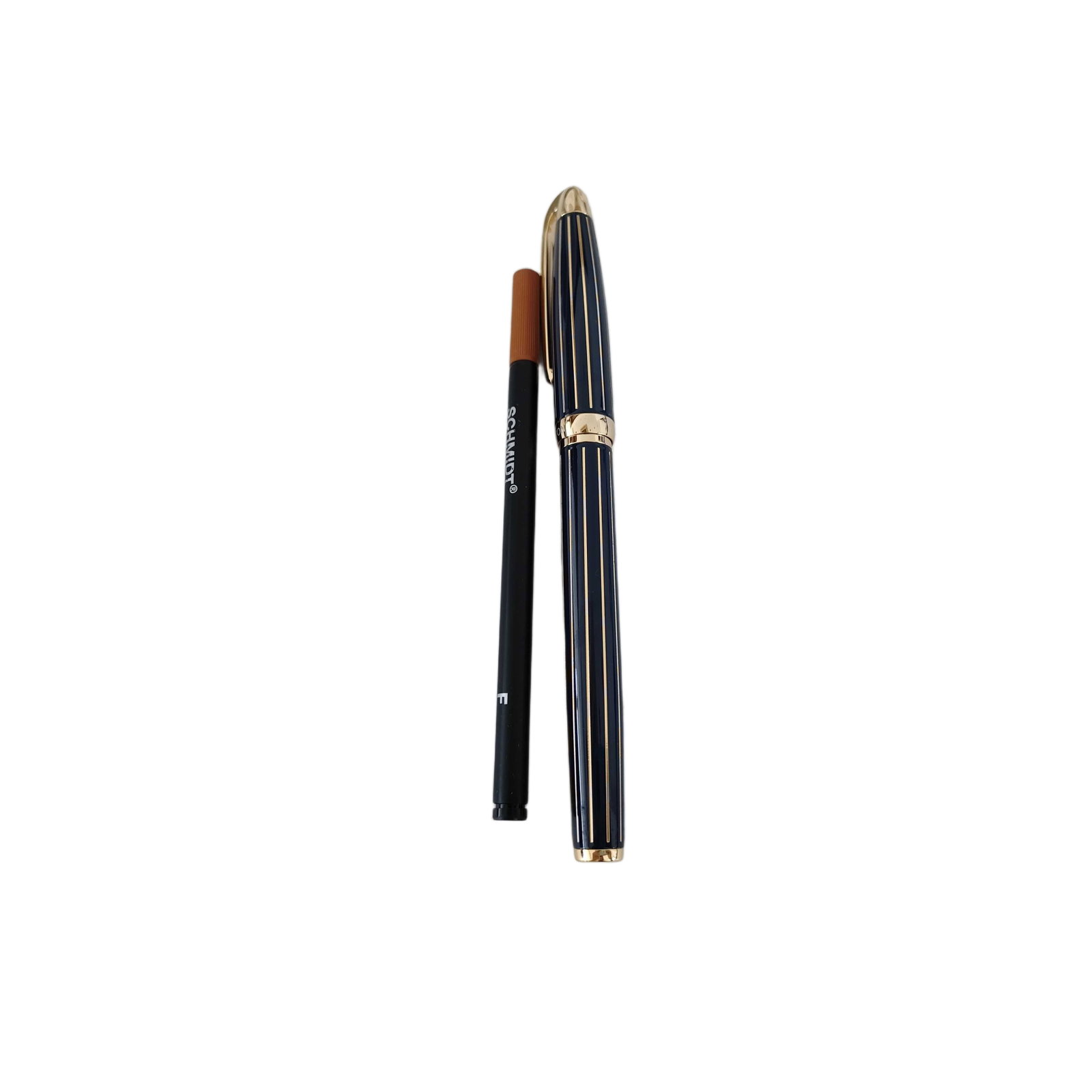 Vintage Harry Winston Black and Gold Tone Striped Ballpoint Pen: Title/Medium: Vintage Harry Winston black and gold tone striped ballpoint pen, with photographed writing accessories. Origin/Year: Vintage; exact origin and date are not specified. Dimensions: Not pro