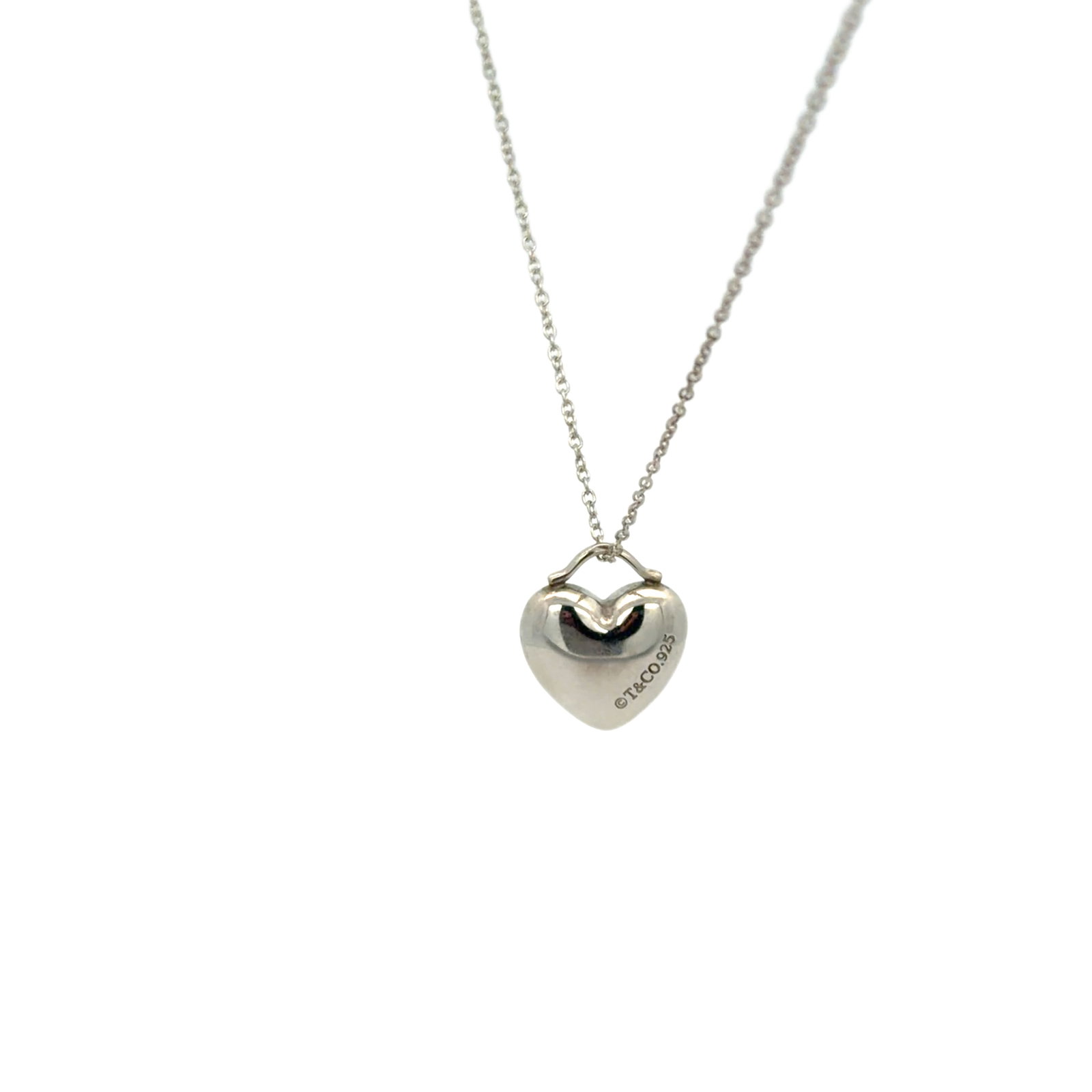 Tiffany & Co. 925 Sterling Silver Puffed Heart Pendant Necklace: Title/Medium: Tiffany & Co. 925 sterling silver puffed heart pendant necklace. Origin/Year: Tiffany & Co.; year not specified. Dimensions: Dimensions not provided. Condition: Condition not specified. 