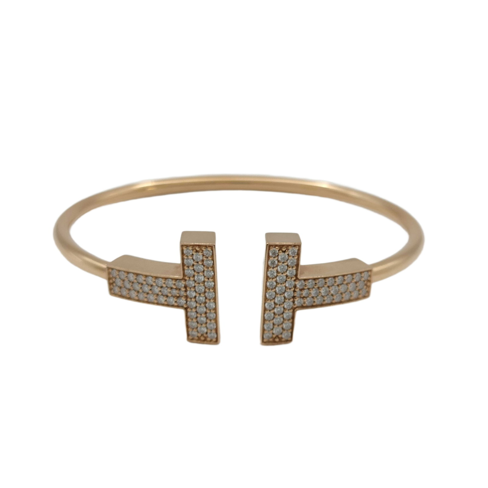 Tiffany & Co. Large T Wire Pave Diamond 18K Rose Gold Bangle Bracelet: Description: Tiffany & Co. T Wire bangle bracelet crafted in 18K rose gold and accented with pave set natural diamonds totaling approximately 0.67 carats. Featuring the collection's iconic T motif
