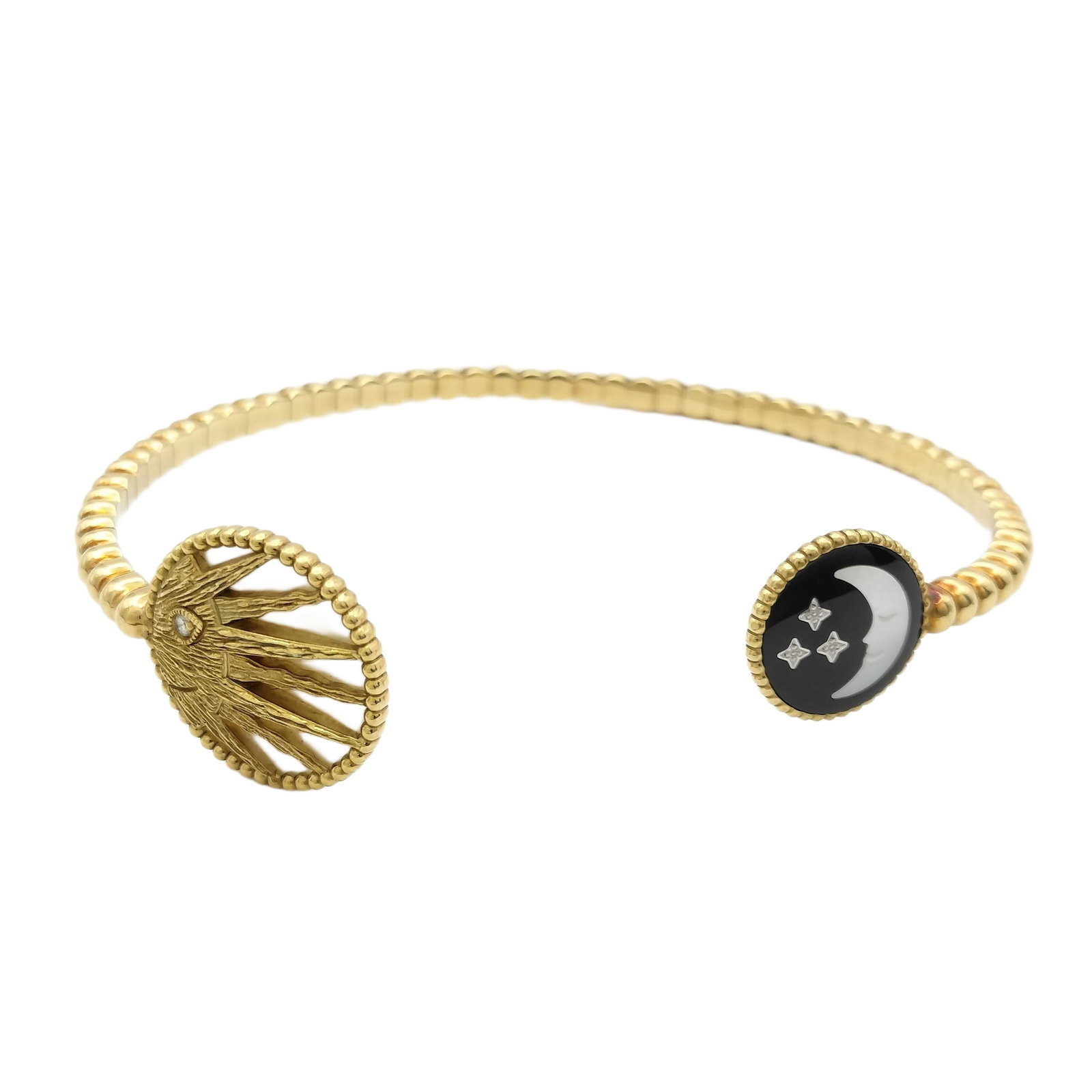 Dior Rose des Vents Sun Moon Mother-of-Pearl Onyx Diamond 18K Gold Open Cuff Bracelet: Description: Distinctive Dior Rose des Vents open cuff bracelet crafted in 18K yellow gold. The design features the iconic compass rose medallion on one side and a contrasting onyx motif set with diam