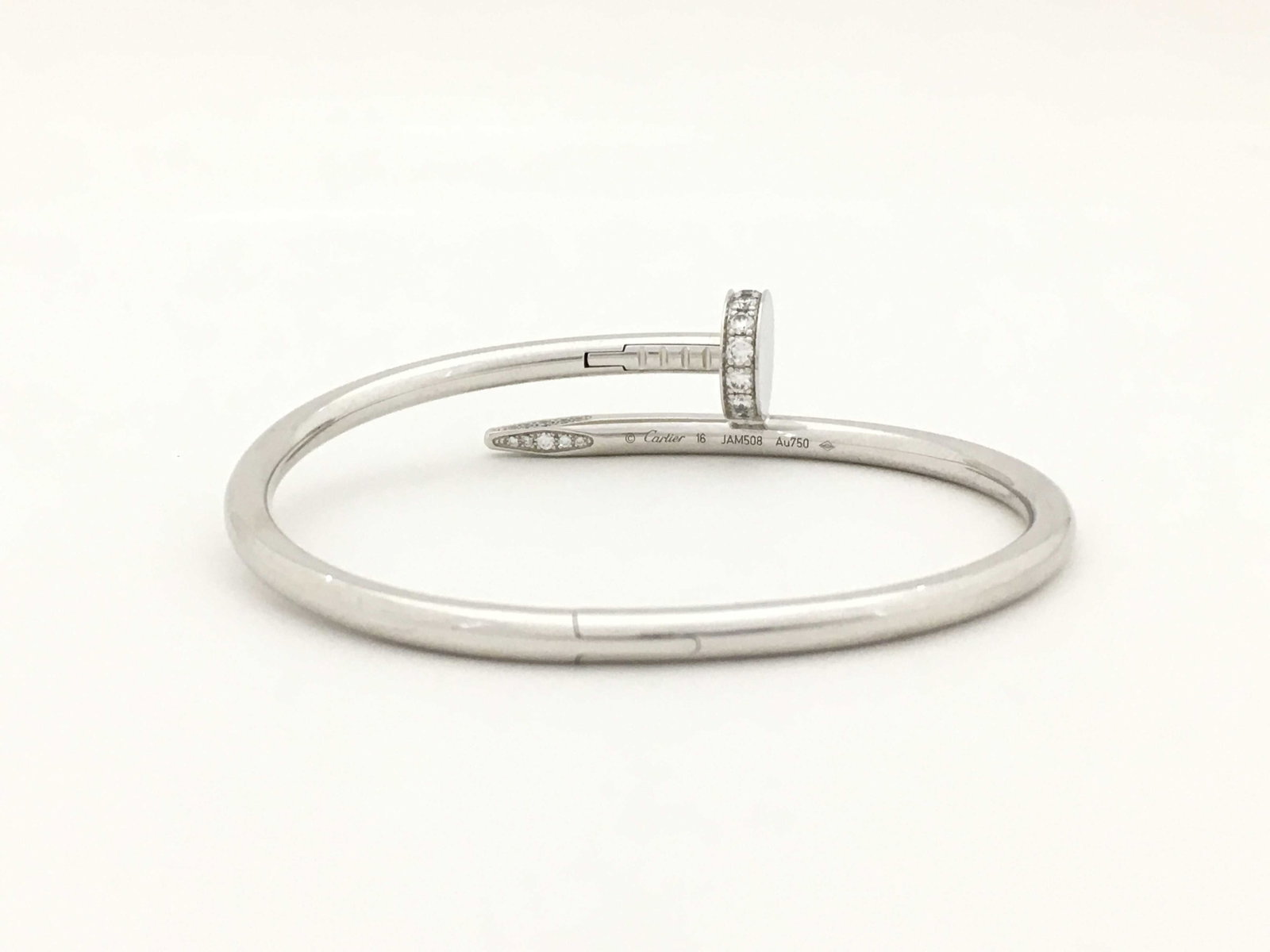 Cartier Juste Un Clou Diamond 18K White Gold Bangle Bracelet Size 16: Description: Iconic Cartier Juste Un Clou bangle bracelet crafted in 18K white gold and accented with diamonds. Inspired by the form of a nail, the Juste Un Clou design transforms a simple industrial 