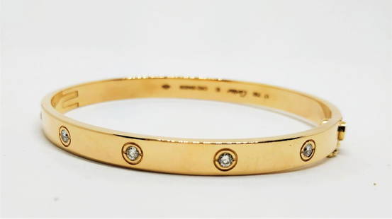 A gold bracelet set with diamonds - signed Cartier: A gold bracelet set with 10 diamonds , signed and numbered by Cartier , size 17 weight- 33.4 gram