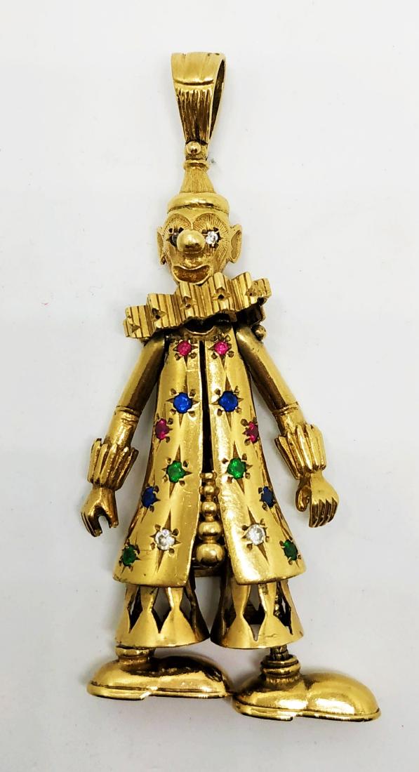Kinetic gold pendant of a clown: Pendant of a clown set with Sapphires emeralds and zirconia stones. Kinetic pendant- legs, head and hands moved 9k gold , signed. weight- 30.1 gram