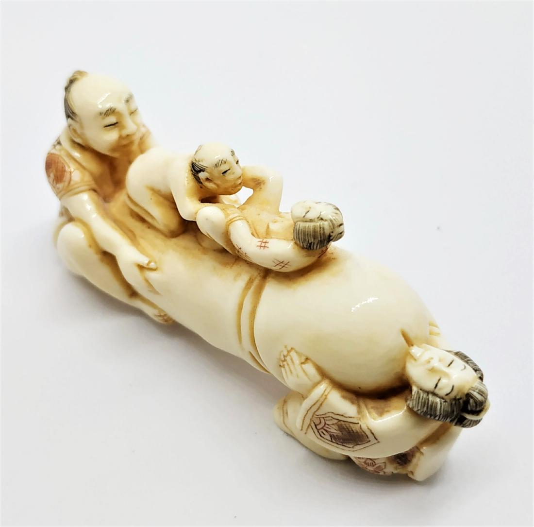 Erotica- participates , Japanese bone carving: figure in the shape of 2 couples making love on a male sexual organ. black and red engravings. signed by a master in red. height- 5 cm period- 20th century , in a very good condition.