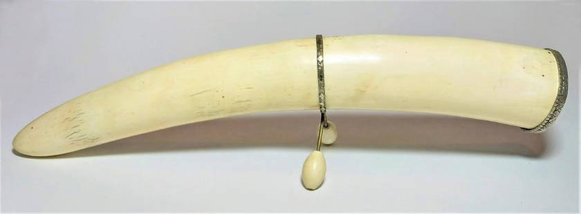 phallic bone tusk with a silver stand and lid: A old bone tusk probably made by a Eskimo on sea lion bone. comes on a silver stand with bone legs and on the end a silver lid with small floral engravings . length- 46 cm, in a very good condition.