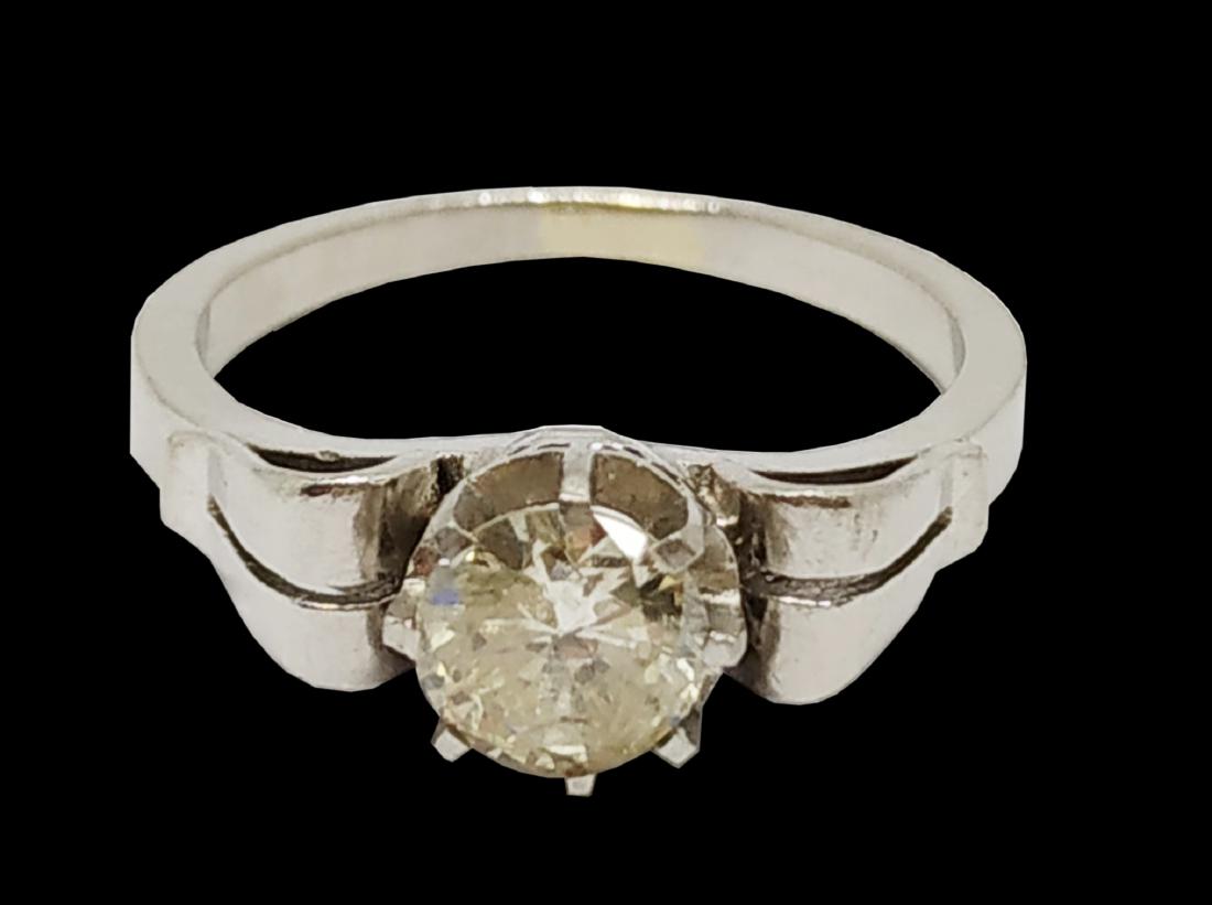 A White Gold and Diamond Solitaire Ring: Containing one round brilliant cut diamond weighing approximately 0.84 carat. Color: J-K Clarity: SI3 Ring Size: 6.5 Weight: 4.7 grams