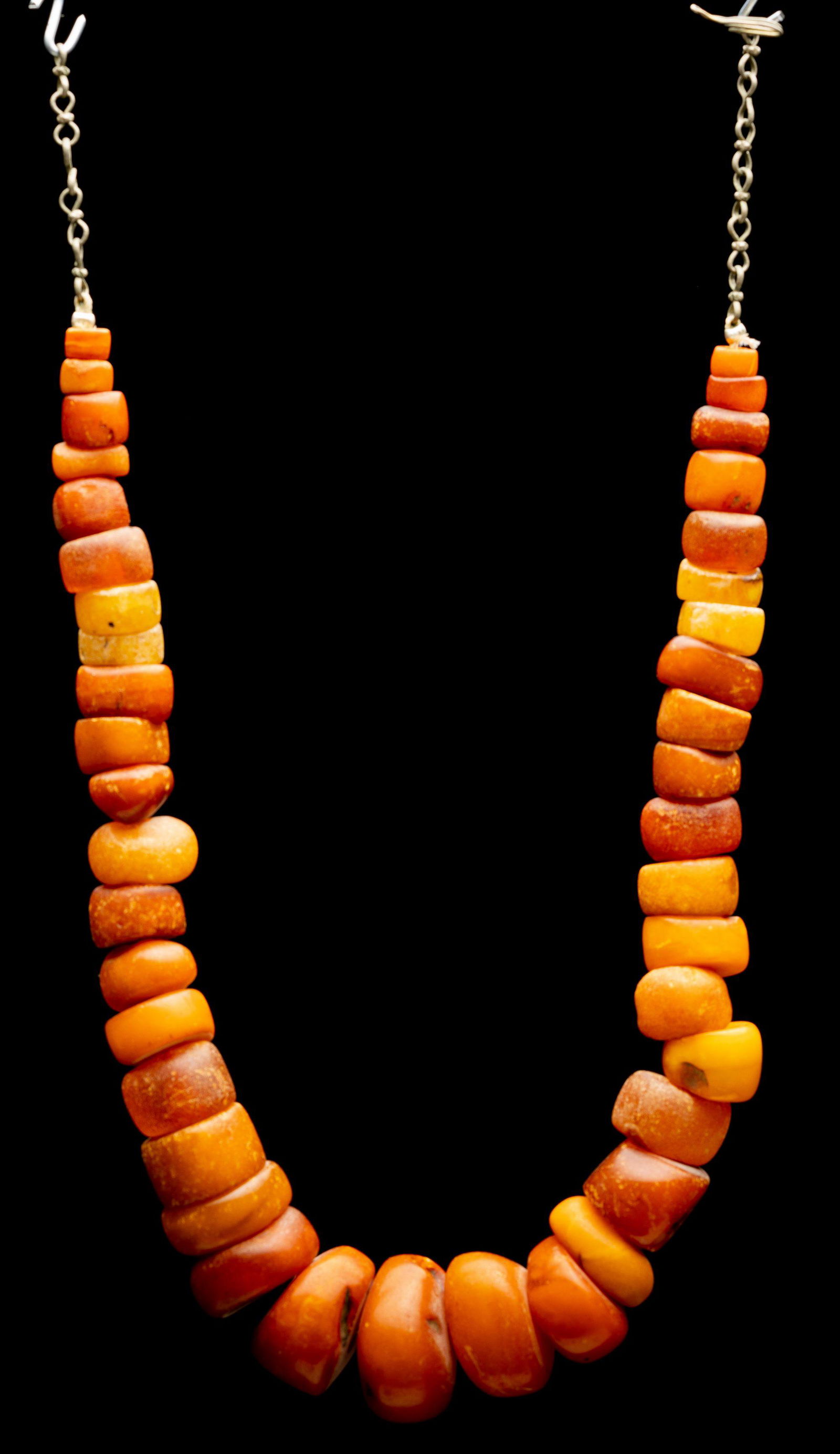 antique amber necklace Morocco 19th century Islamic: The necklace is comprised of 41 hand carved amber beads. Most of them are of butter scotch color. A chain with a hook attached for wearing. weight: 80 gram length: 39 cm bead size: 8-28 mm *Amber was