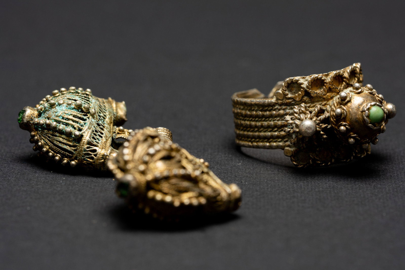 Silver ornaments Yemen Islamic Jewish: 1.The basket shaped ornaments are made of gilded silver and are set with green stones. They were used as attachments to chains that were sewn onto the head garment of a Yemenite woman. They are also u