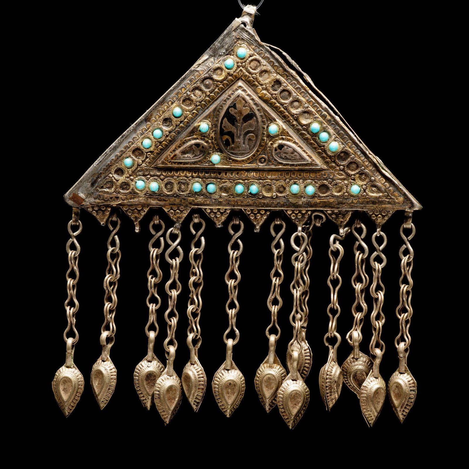 silver pendant- Uzbekistan 19th century islamic Jewish: A triangular silver pendant set with Turquoise ( some missing) Tassels hang from the bottom of the pendant. Floral engraving on both sides Niello work has partially faded. silver has been checked. len