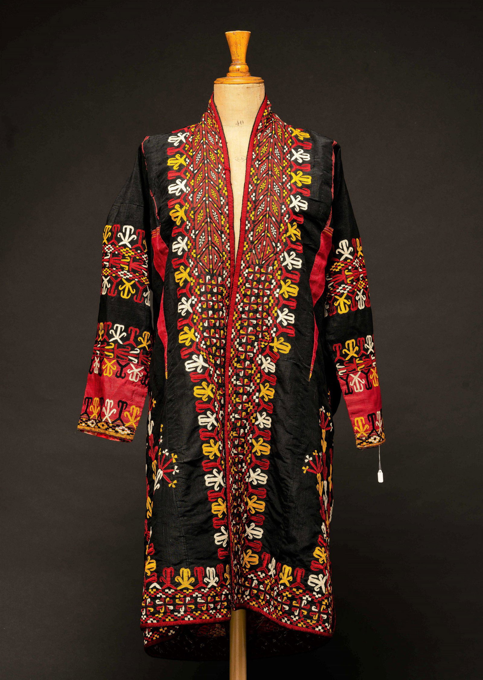 embroidered robe Turkmenistan Bukhara islam Jewish: The robe is formed from black and burgundy woven fabric. Organic embroidery covers the much of the robe. Rose motif lining. woven, embroidered, sewn dimensions: 96*145 some fraying to the cloth.