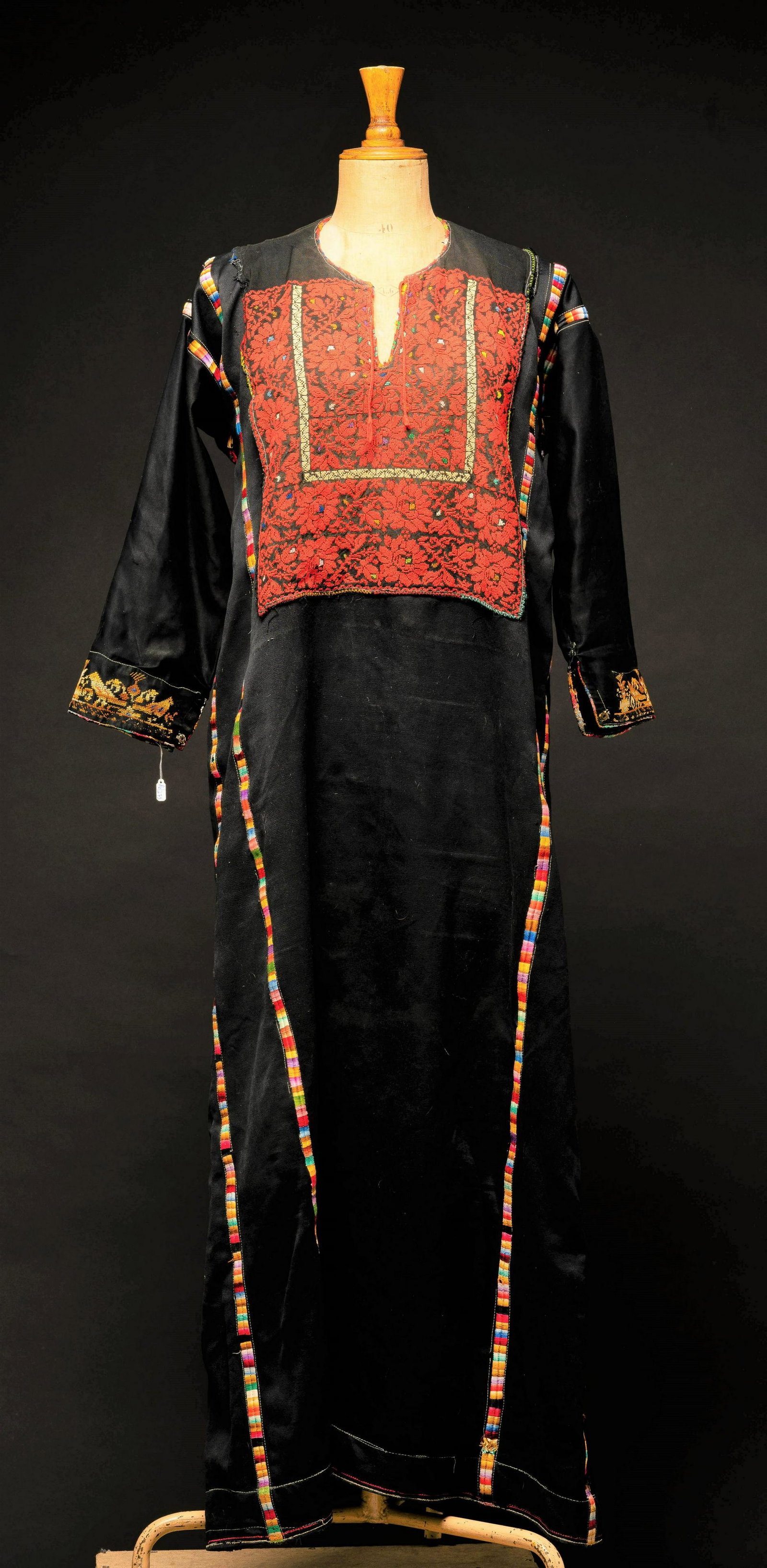 embroidered Palestinian dress: embroidered Palestinian dress - Thobe, made out of black viscose fabric decorated with colorful embroidery. neck line has a tie. 20th century. length: 140 cm width (including sleeve): 138 cm in a gene
