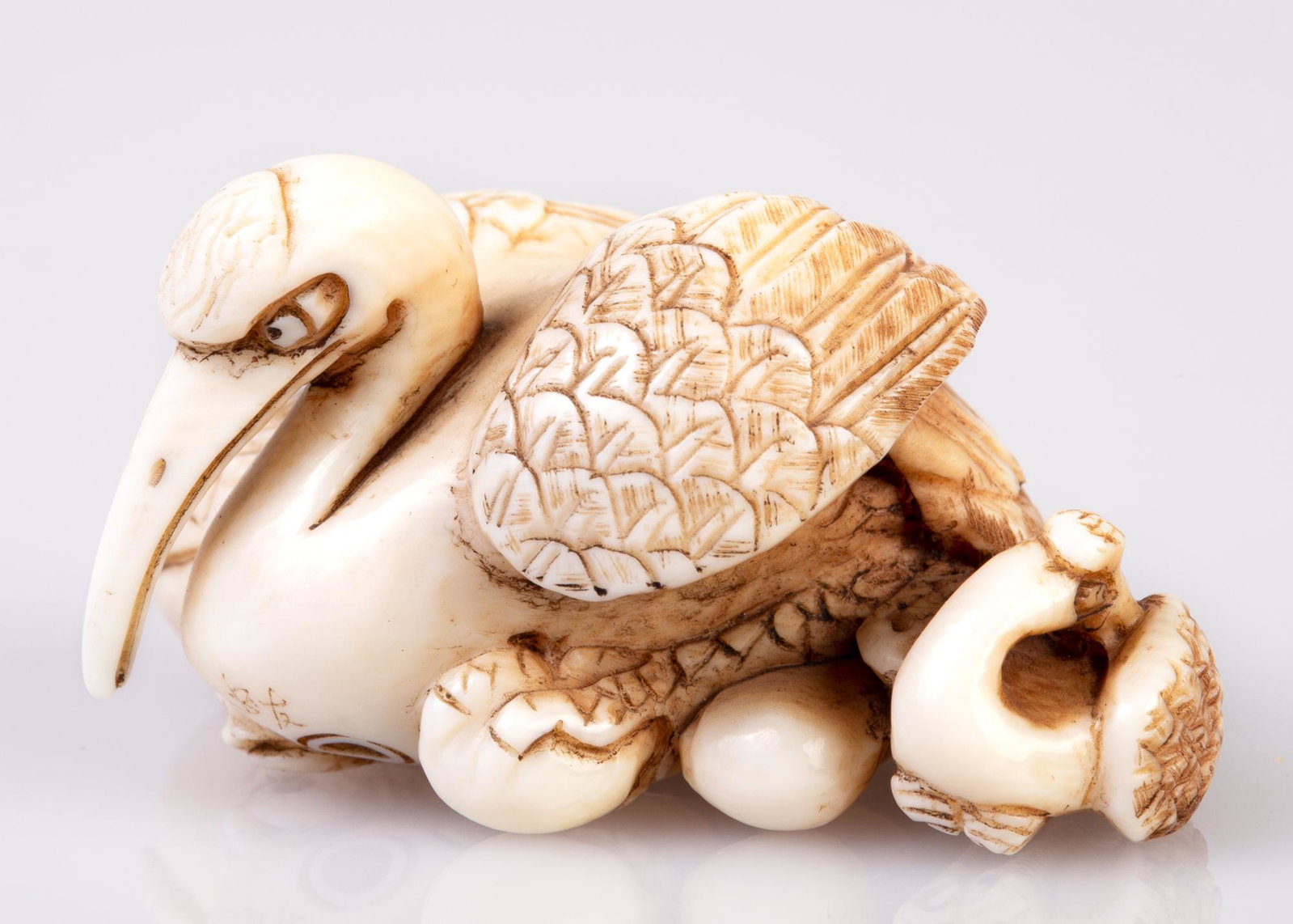 fine antler / bone netsuke: Nestling cranes and chick , H 2.8, L 5.1 cm. W 3.1 cm [no.50 in 1983.catalog] [Source: from a private collection. Insurance documents are attached to the item, indicating that the item was assessed in
