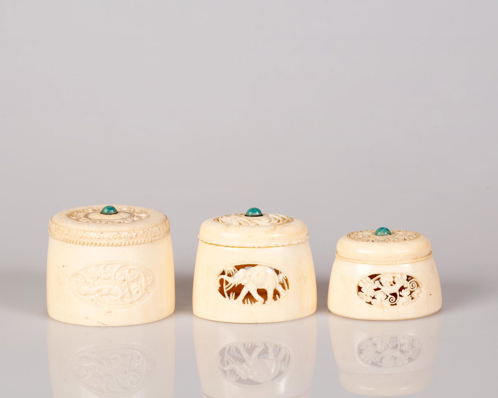 Three Burmese Hand Carved Bone Boxes w/ Lid: Three Burmese Hand Carved Bone Boxes with a lid set with a Turquoise stone. Very special items. Dimensions: 3X4, 4X5, 5X5 cm.