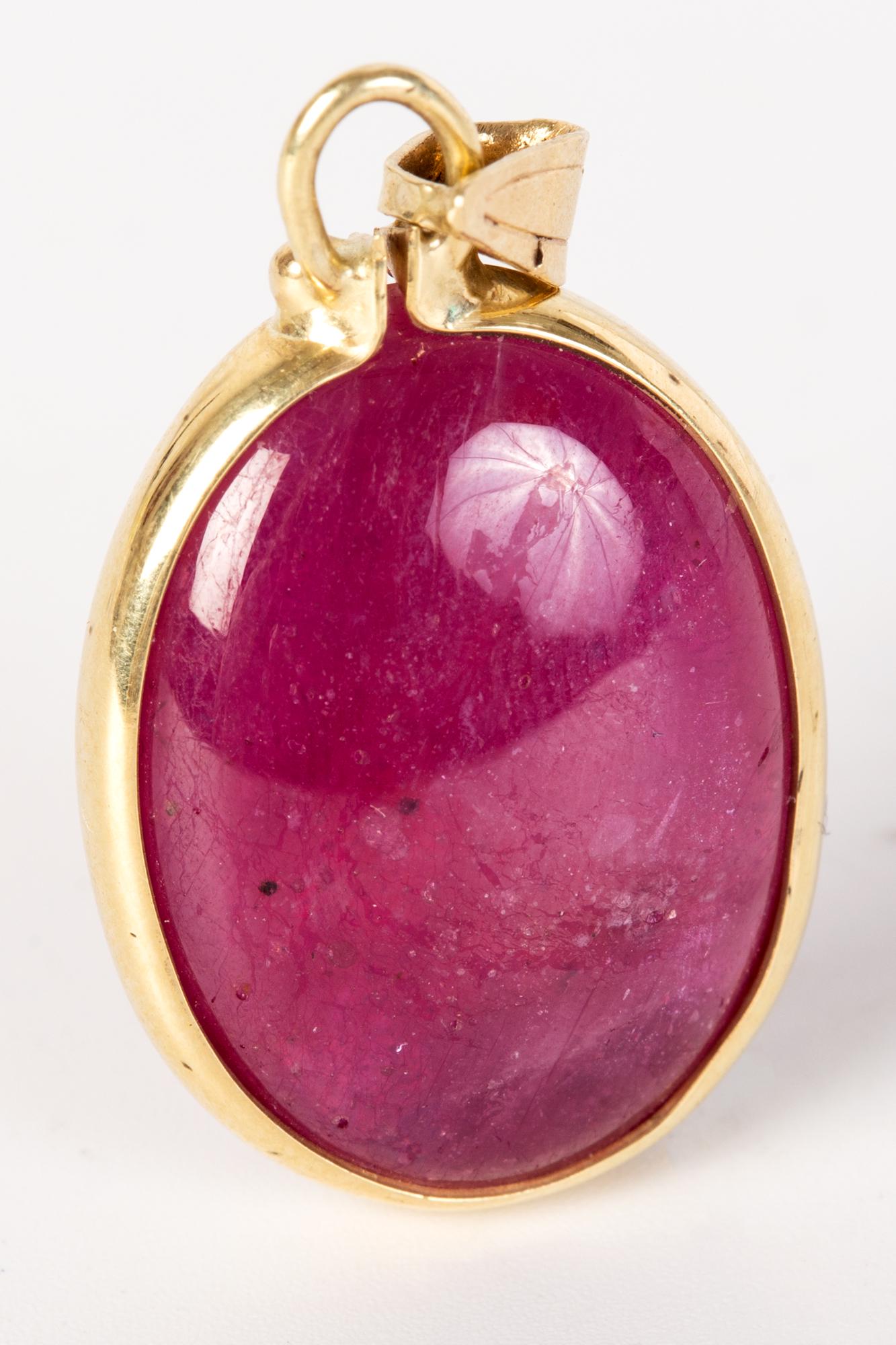 A 14k gold pendant with a large ruby (1 of 2)