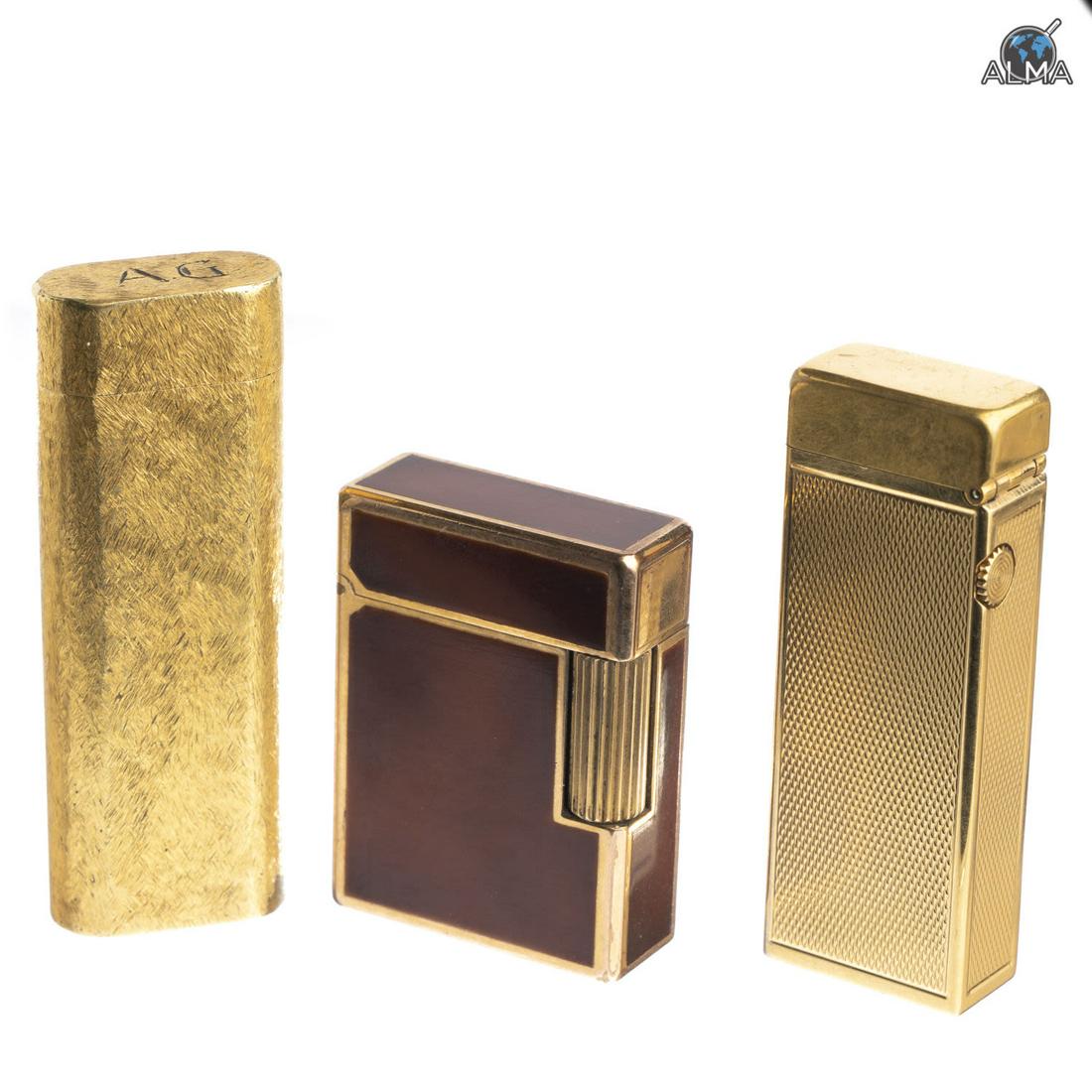 Three Golden Lighters Made by Different Companies: The lighters are made by 'Cartier', 'Dunhil' and 'Dupont', marked. Length: 5-8 cm.