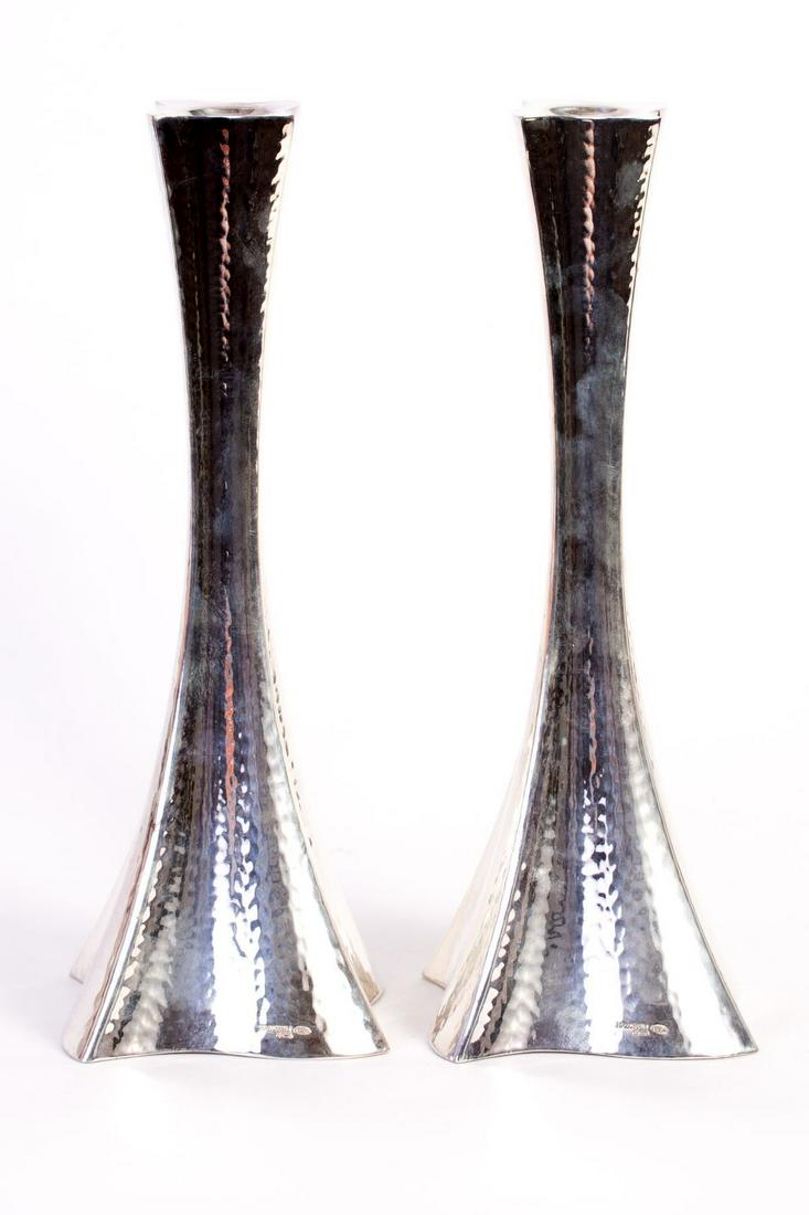 A pair of silver candlesticks set in a modern design (1 of 3)