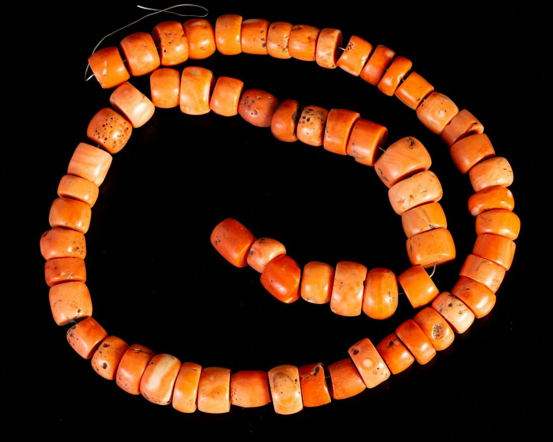 Row of Fine Large-sized Salmon-Shaded Corals: Row of fine Salmon-shaded Corals. Could easily be converted to a lovely beaded necklace by adding a clasp and lace. Bead dimensions: 11-16 mm. Length: 60 cm. Total weight: 194 grams.