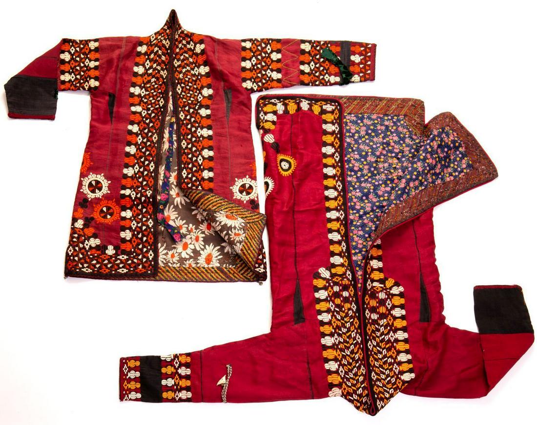 Two Turkmeni Kaftans Decorated w/ Embroidery: Two Turkmeni Kaftans from beginning of 20th century decorated with embroidery in a floral geometrical pattern in shades of orange and white over a maroon background. Wear in accordance with its age. D