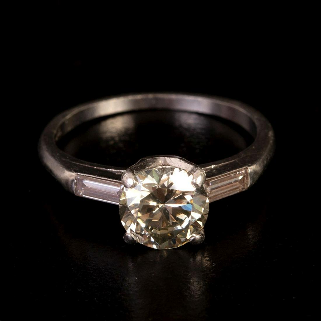 Platinum Art-Deco Ring Set w/ Central Diamond Weighing 1.4 Carats: Art-Deco Solitaire ring made of platinum (marked) and set in its center with a diamonds weighing approximately 1.4 Carats in a light Champagne shade (SI/VS , O-Q), and on its walls with two Tape Cut d