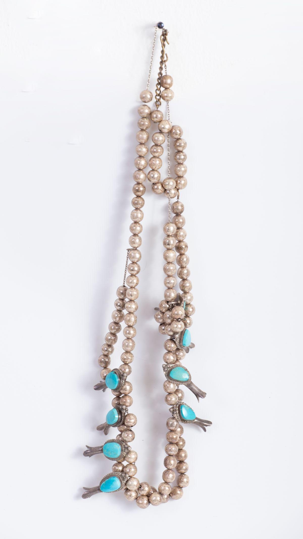 Navajo Silver Necklace Set w/ Turquoises - Beginning of 20th century: The necklace is in a "Squash Blossom" design of silver beads laced on a thin link chain, decorated with silver pomegranates set with Turquoises. Necklace length: 65 cm Weight: 110 grams