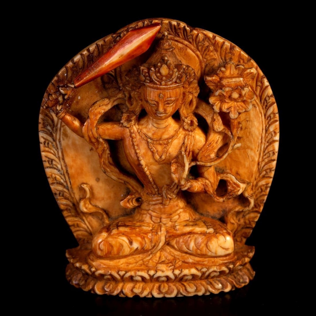 Tibetan Carving Figure of MaÃ±juÅ›rÄ«, 18th c China: Tibetan carving in the figure of MañjuÅ›rÄ« made of organic material, 18th century. The sword's end went through repair. Dimensions: 4.5X5.5 cm.