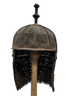 Tibetan Helmet Made of Steel 18/19th Century: The cap of the helmet is decorated with add-ons that create a geometric pattern and ends with an ornamental rod in the center of the head, and a pointed visor helmet on the face, The nape of the