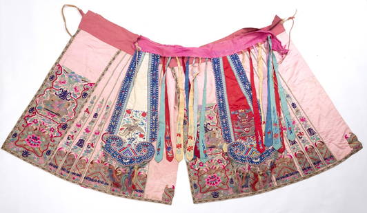 Embroidered Chinese skirt: A traditional Chinese skirt cover, combined with many ribbons over three central pieces, all embroidered with typical motifs of calligraphy, peacocks and organic patterns  Dimensions: 92-120 cm   Mino