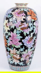 Especially Large Chinese Porcelain Vase w/ Floral Enameling, Early 20th c: An exceptionally large Chinese porcelain vase, early 20th century. Enameling in a plethora of colors over a black enamel background in a model of flowers and leaves, and gilding to the top ring. 