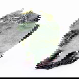 An archaic jade vessel, from China.: Designed in the form of a mythical creature. Beautiful geometric carving on the surface of the vessel, with the back of the creature serving as the lid for the vessel. The item stands on a matching