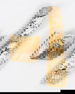 Two miniature statues carved from white material: One of the sculptures depicts a group of pigs, and the other portrays egg-laying animals such as frogs, crabs, and turtles. They are finely detailed with engravings and black coloring. The other side