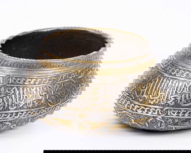 Islamic vase decorated with Damascus work - 19th century: And this is a richly adorned 19th-century Islamic piece with Damascus work - silver filigree inlay in Islamic calligraphy and geometric patterns, as well as intricate and densely engraved handwork. 