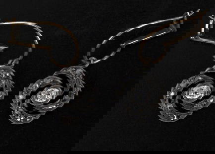 10K gold and silver art nouveau earrings with diamonds: A pair of Art Nouveau earrings made of 10 karat gold (the upper part) and silver (the floral part), embellished with antique-cut diamonds combined with a total weight of approximately 0.3 carats.