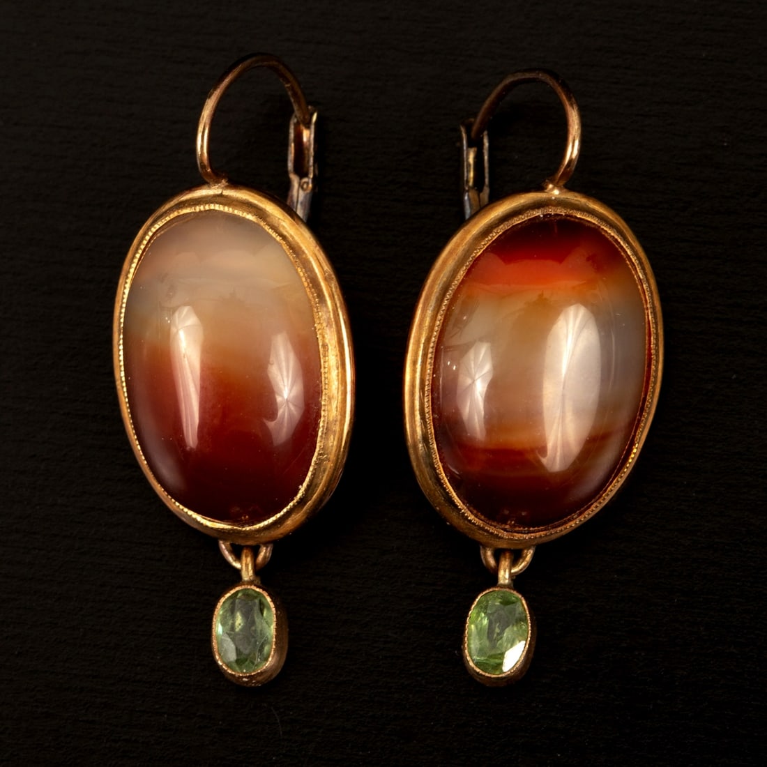 A Pair of Antique 14K Gold Agate and Peridot Earrings: Containing two oval shape cabochon cut agates measuring 18.0 x 12.5 mm together with two oval shape mixed cut peridots. Stamp: 585 Weight: 8.6 grams