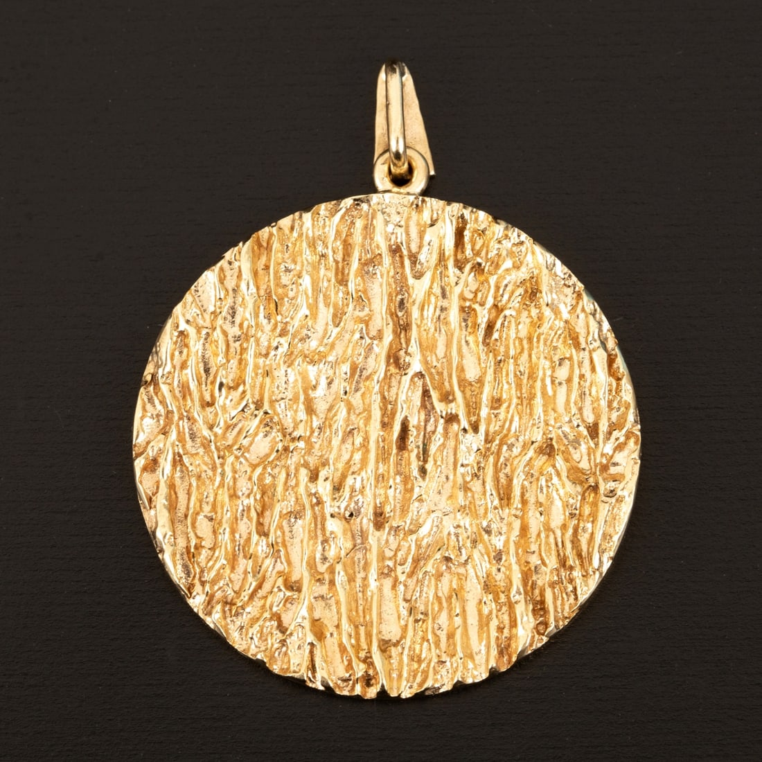 A 9 Karat Yellow Gold Brutalist Pendant: Textured finish crafted in the brutalist style popular in the 1950's, and measuring 3.5 cm in diameter. Stamp: 375 (British hallmarks)
