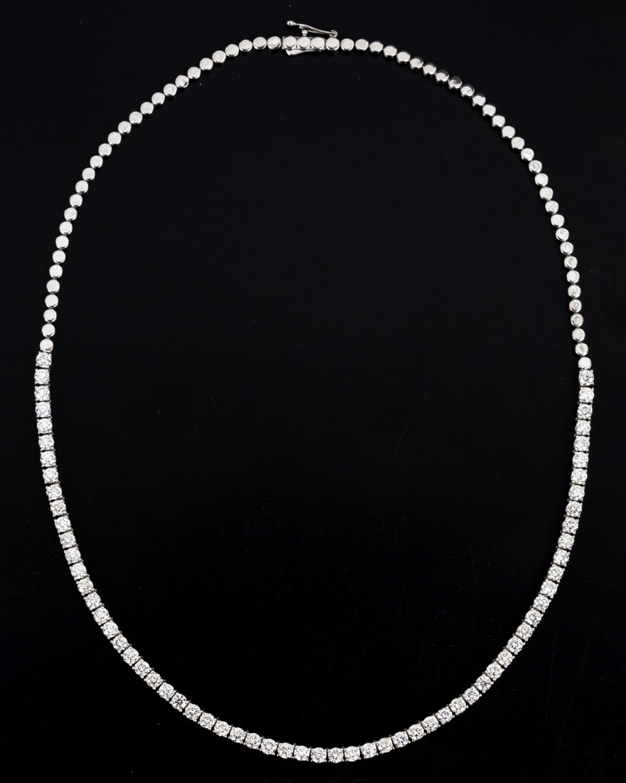 An Elegant 14K White Gold and Diamond Tennis Necklace: Containing numerous round brilliant cut diamonds weighing 9.65 carats total. The necklace measures approximately 45 cm in length. The necklace is accompanied by Swiss Gemological Laboratory report J10